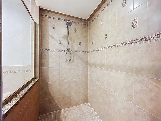 a view of a house with wooden deck and furniture