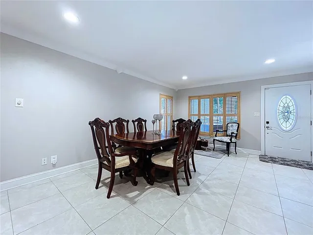 a view of a a dining room with furniture window and wooden floor