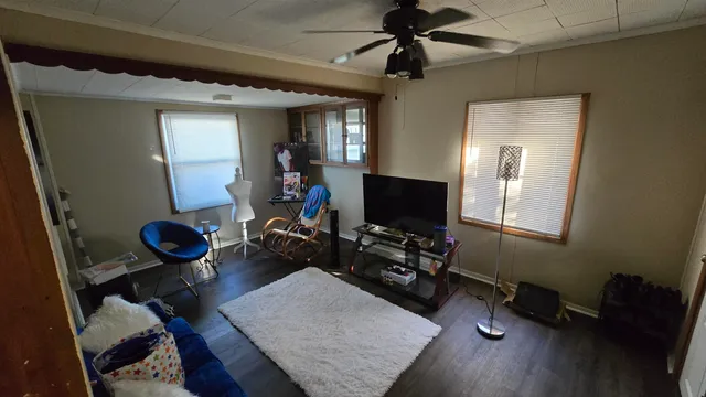 a view of a workspace with furniture and a window