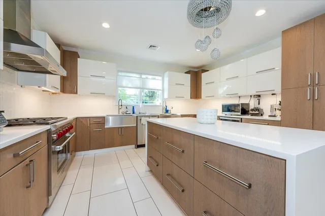 a kitchen with stainless steel appliances granite countertop a sink and cabinets