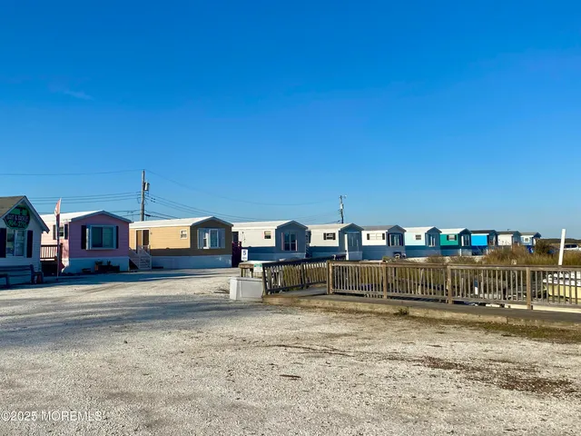 a kitchen with stainless steel appliances granite countertop a refrigerator a stove and a wooden cabinets