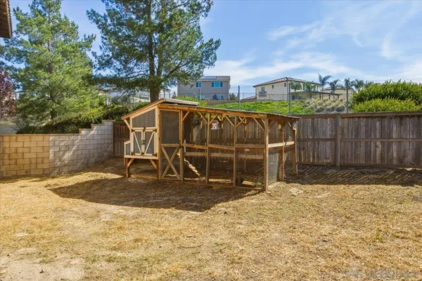 a backyard of a house with basket ball court
