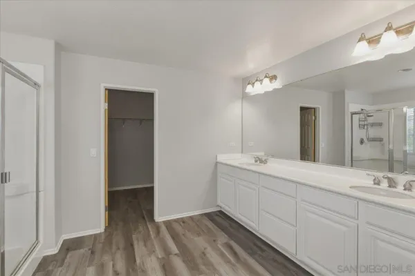 a bathroom with a double vanity sink and mirror