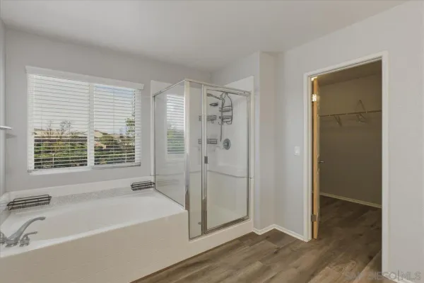 a bathroom with a bathtub and a shower