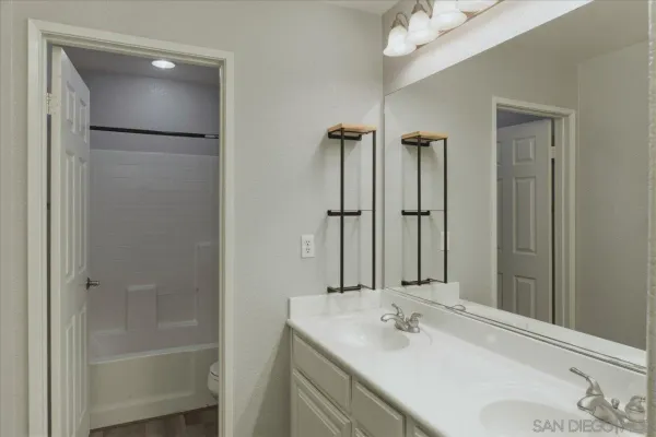 a bathroom with a bathtub a sink and mirror