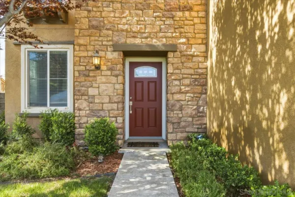 a front view of a house with a door and a yard