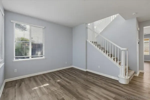 a view of room with window and hardwood floor