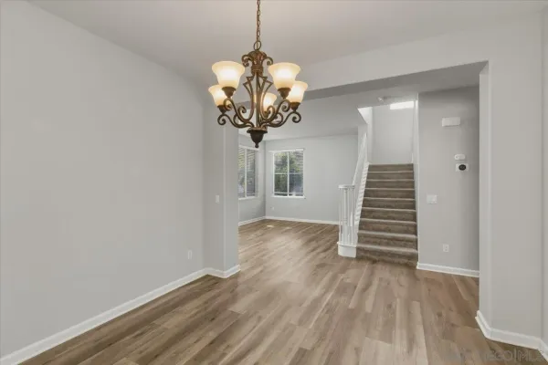 a view of a room with wooden floor and a window