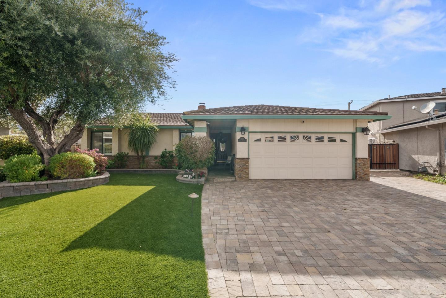 a view of a house with a yard and garage