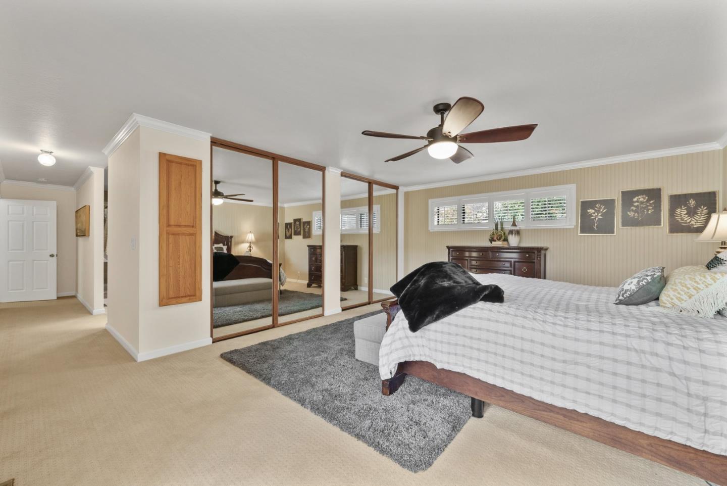 1664 Corte De Pons San Jose, CA 95124 - Photo 16 of 39 a bedroom with a bed and a large mirror with a ceiling fan