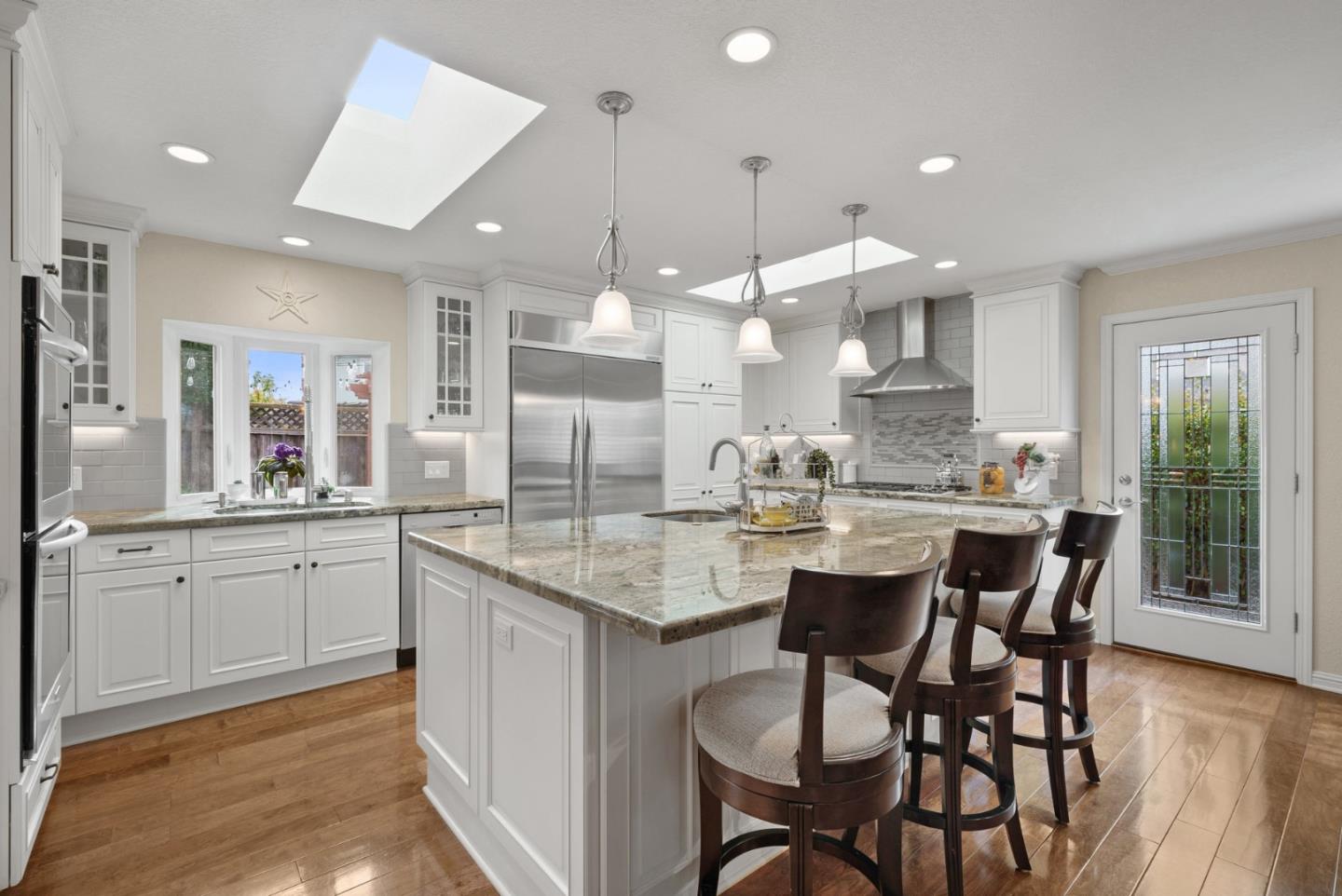 1664 Corte De Pons San Jose, CA 95124 - Photo 7 of 39 a kitchen with center island wooden cabinets and stainless steel appliances