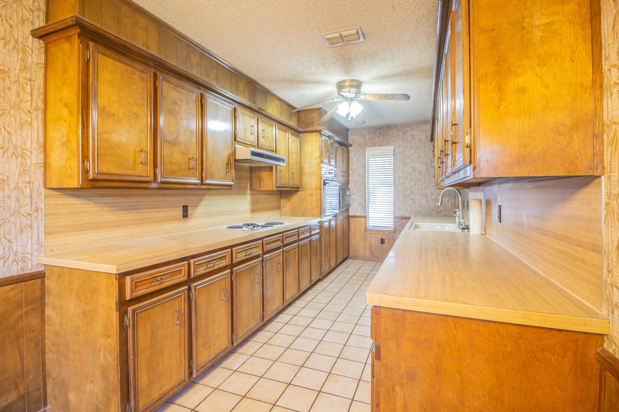 3503 91st Street Lubbock, TX 79423 - Photo 12 of 23 a kitchen with stainless steel appliances a sink a stove and a refrigerator