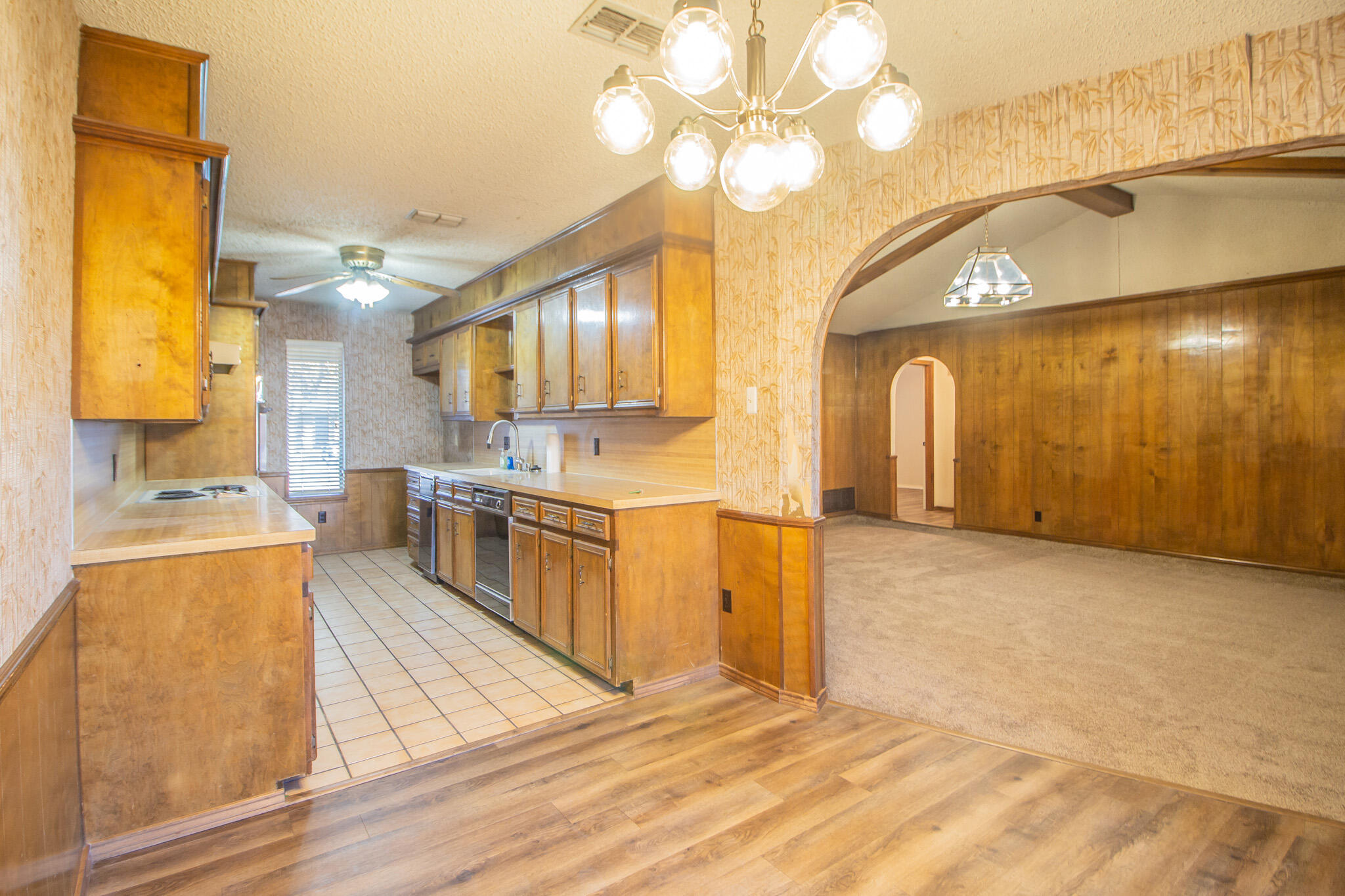 3503 91st Street Lubbock, TX 79423 - Photo 13 of 23 a large kitchen with stainless steel appliances granite countertop a stove a sink and a microwave