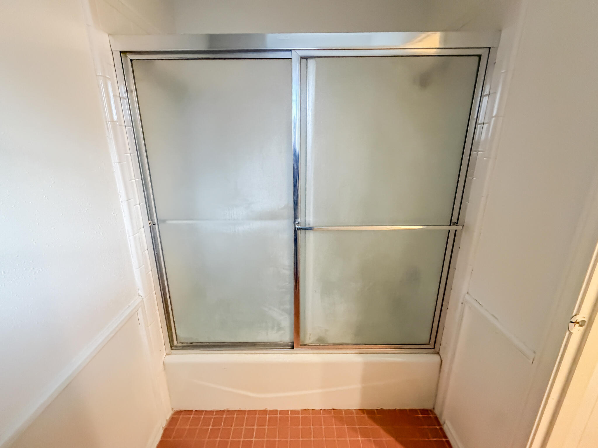 3503 91st Street Lubbock, TX 79423 - Photo 16 of 23 a bathroom with a glass shower door