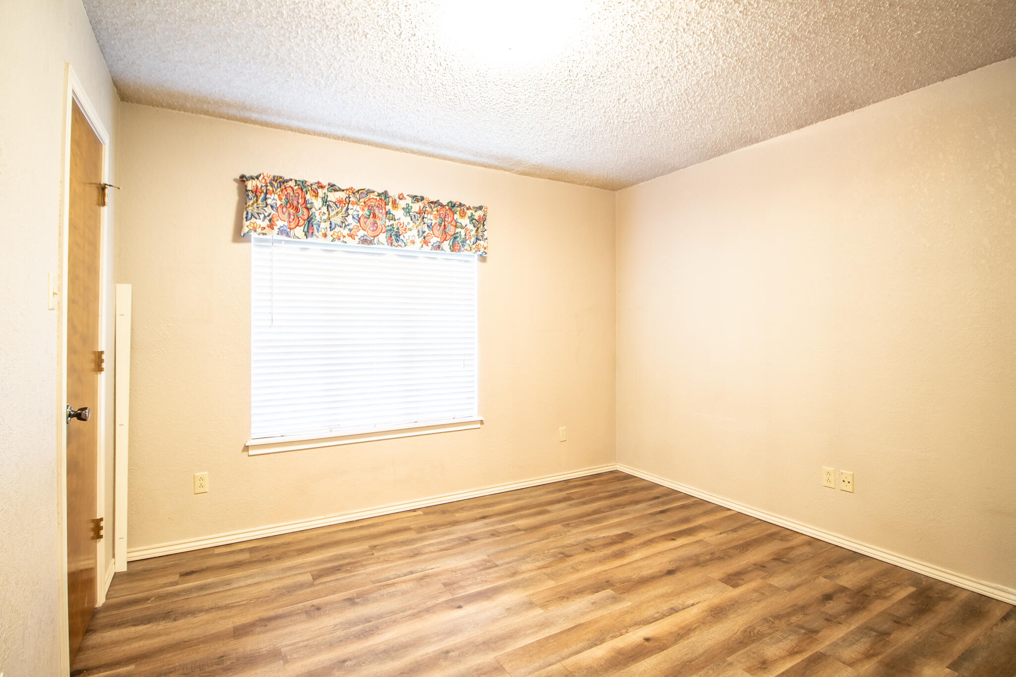 3503 91st Street Lubbock, TX 79423 - Photo 18 of 23 a view of empty room with wooden floor