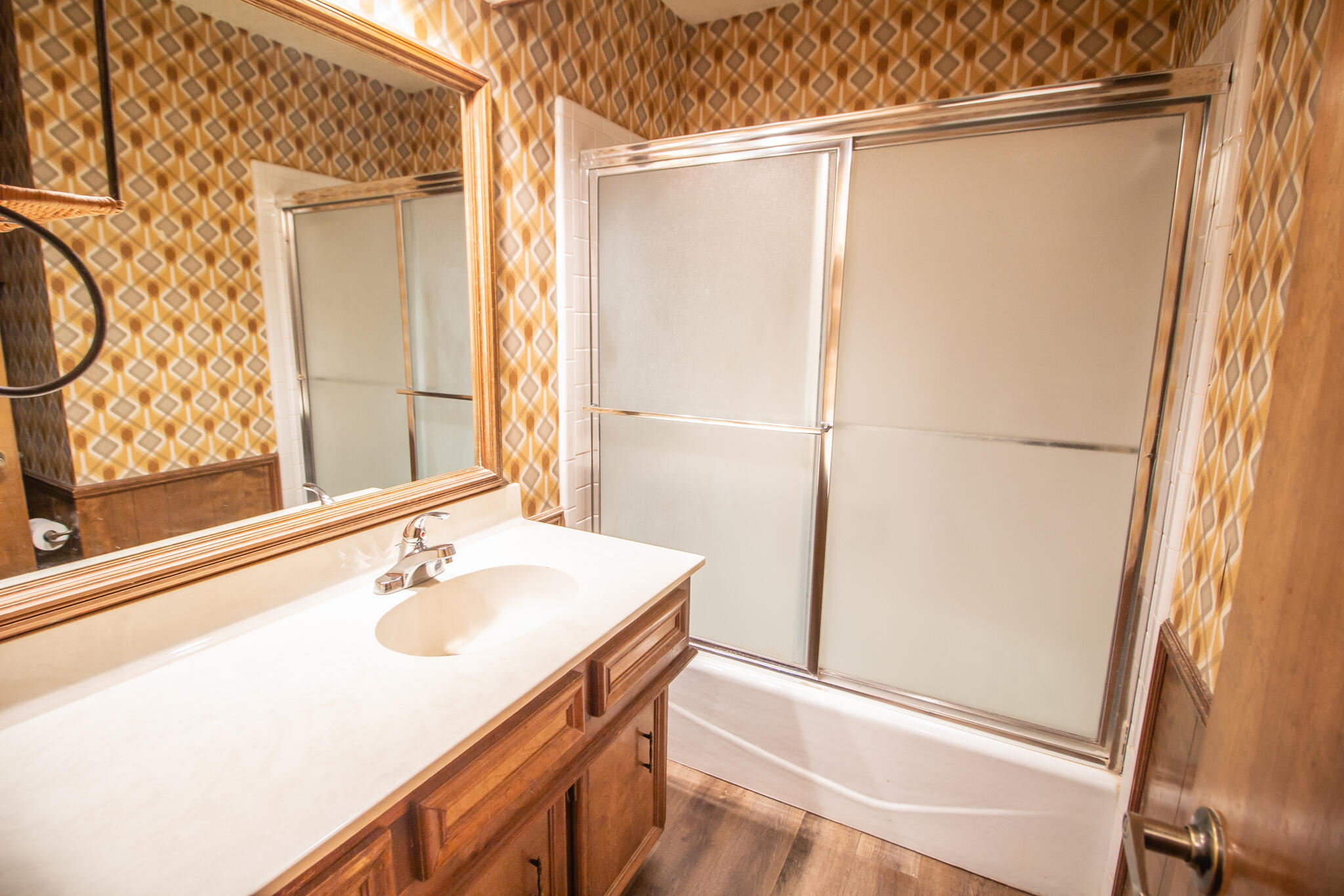 3503 91st Street Lubbock, TX 79423 - Photo 19 of 23 a bathroom with a sink and mirror with shower