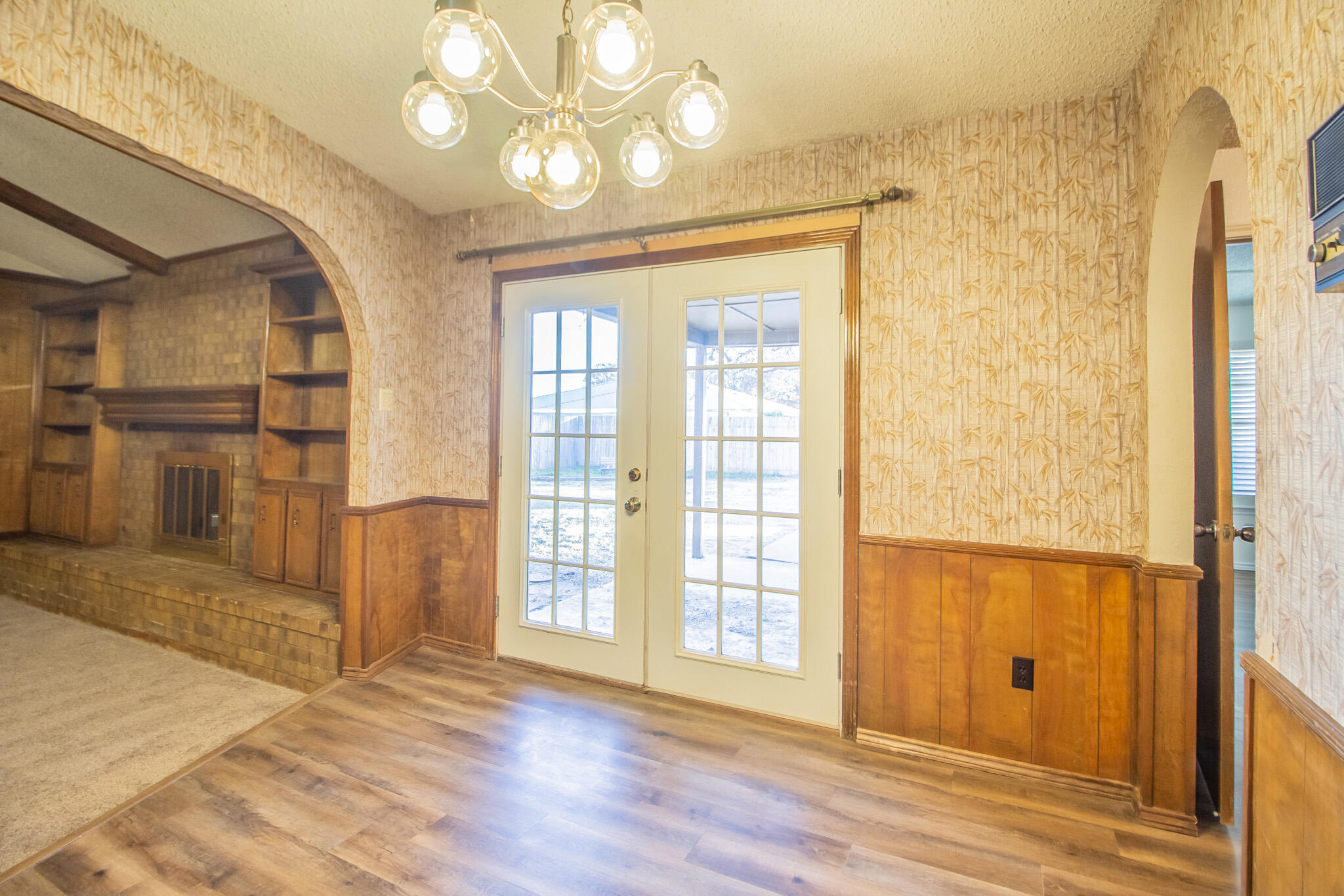 3503 91st Street Lubbock, TX 79423 - Photo 7 of 23 wooden floor in an empty room with a window