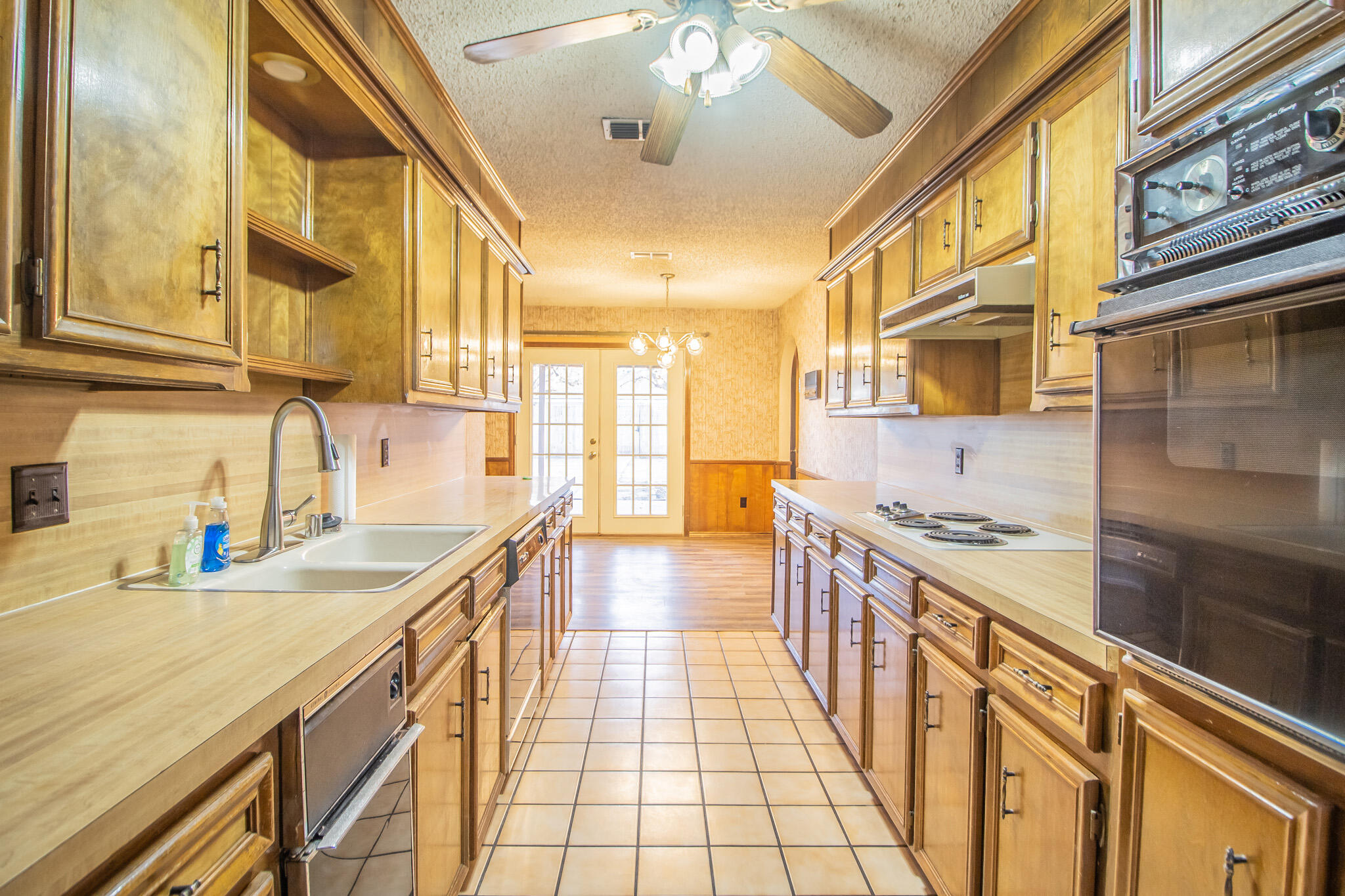 3503 91st Street Lubbock, TX 79423 - Photo 8 of 23 a kitchen with stainless steel appliances granite countertop a sink and stove