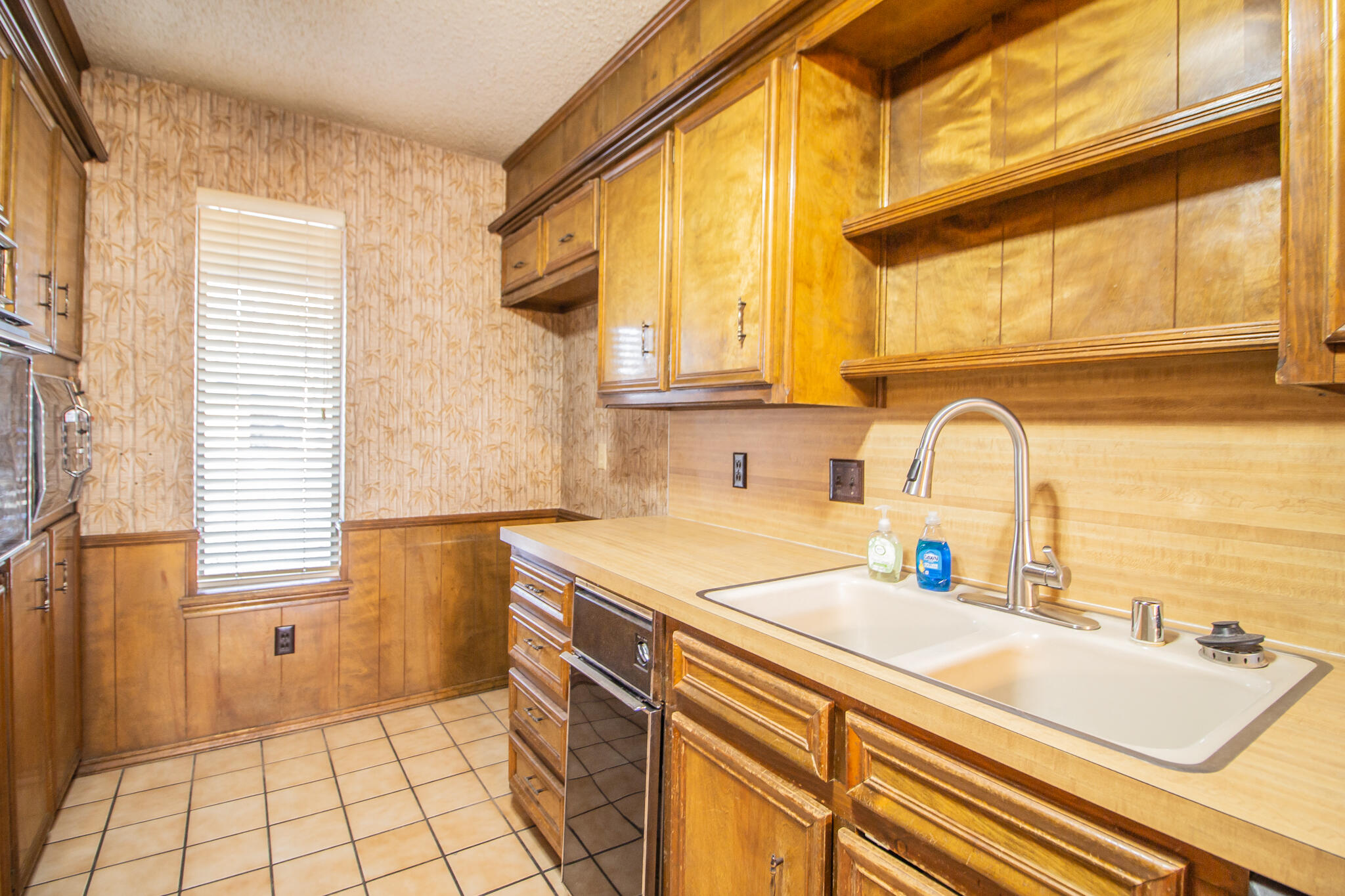 3503 91st Street Lubbock, TX 79423 - Photo 9 of 23 a kitchen with a sink and a window