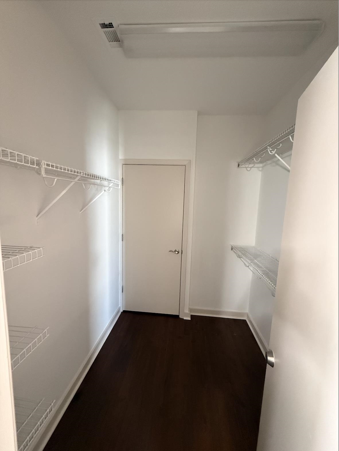 379 Cobalt Bay Loop, Unit 304 Memphis, TN 38103 - Photo 11 of 24 Walk in closet featuring dark wood floors and great amount of shelving