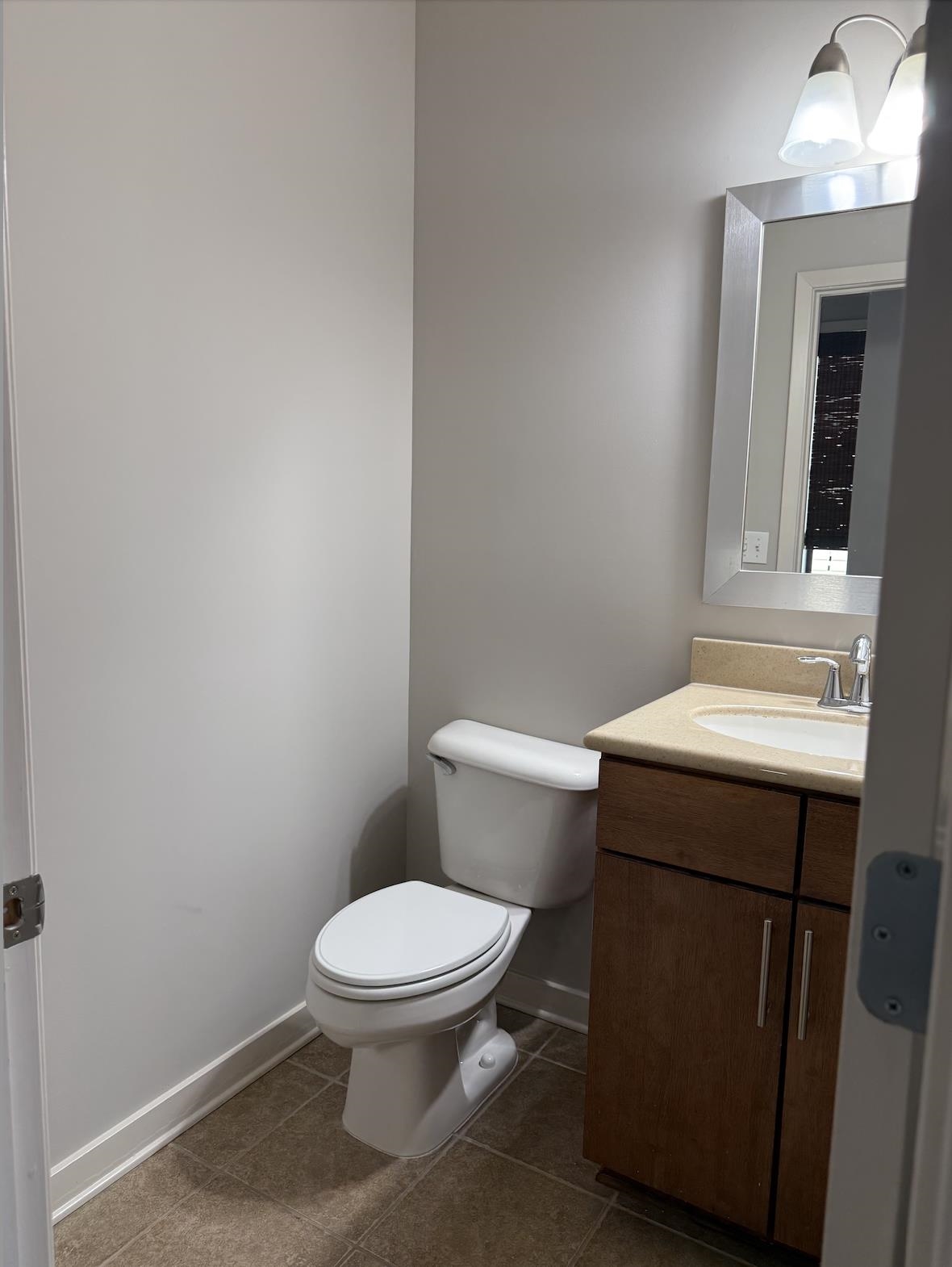 379 Cobalt Bay Loop, Unit 304 Memphis, TN 38103 - Photo 13 of 24 a white toilet sitting next to a bathroom sink