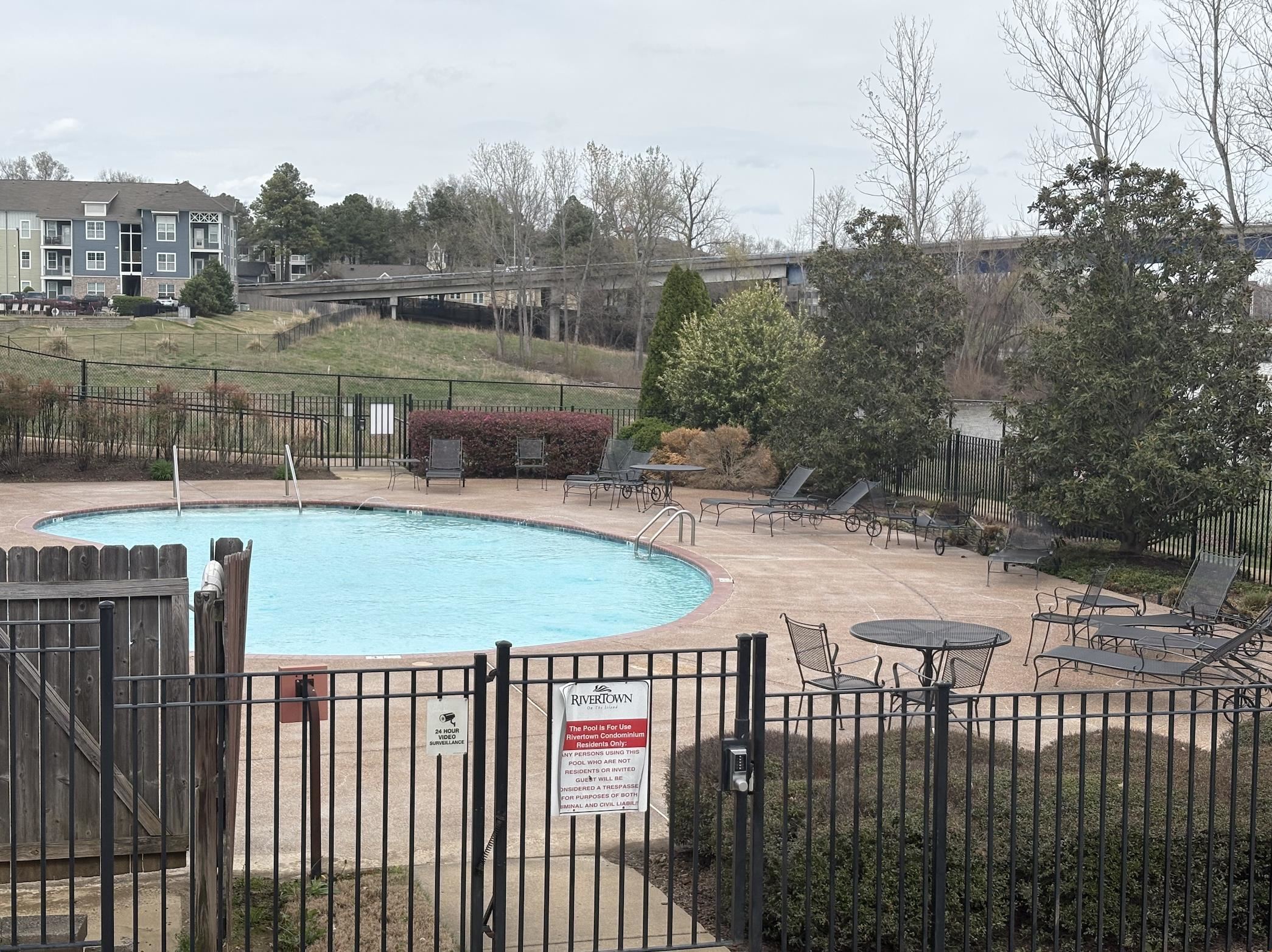 379 Cobalt Bay Loop, Unit 304 Memphis, TN 38103 - Photo 21 of 24 a view of a swimming pool and lake from a terrace