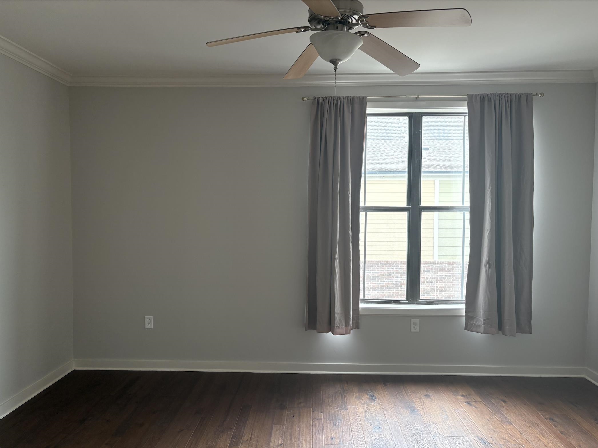 379 Cobalt Bay Loop, Unit 304 Memphis, TN 38103 - Photo 8 of 24 an empty room with wooden floor windows and fan