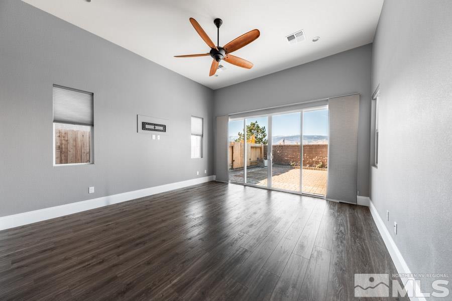 9405 Stony Hill Road Reno, NV 89521 - Photo 17 of 37 an empty room with wooden floor and ceiling fan
