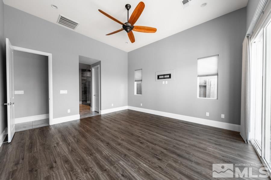 9405 Stony Hill Road Reno, NV 89521 - Photo 18 of 37 a view of an empty room with wooden floor and a window