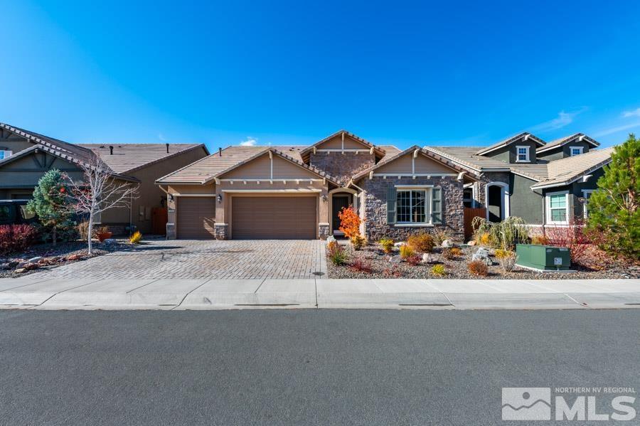 9405 Stony Hill Road Reno, NV 89521 - Photo 2 of 37 a front view of a house with a garden and porch