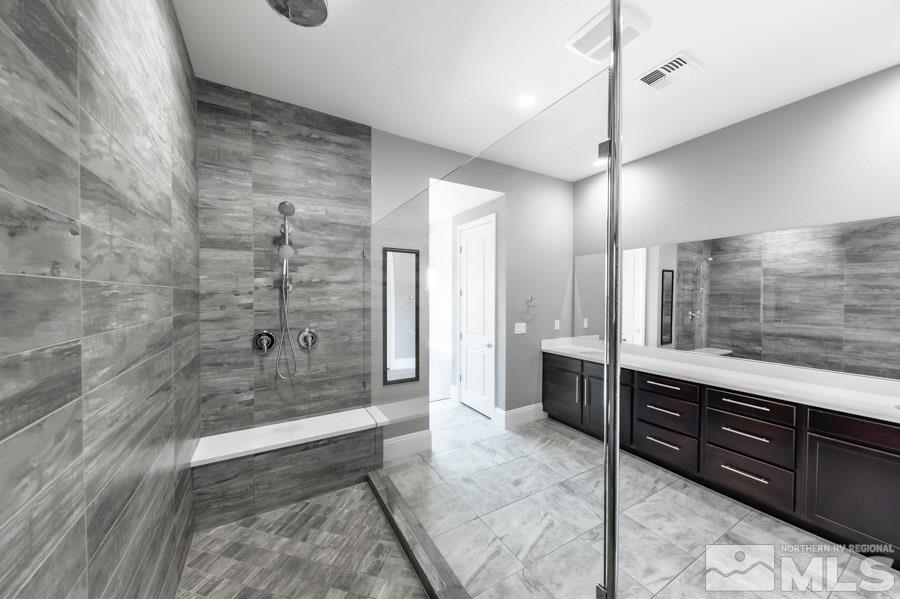 9405 Stony Hill Road Reno, NV 89521 - Photo 21 of 37 a spacious bathroom with a sink a mirror a bathtub and shower