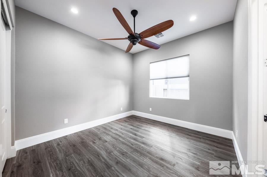 9405 Stony Hill Road Reno, NV 89521 - Photo 26 of 37 an empty room with wooden floor and windows