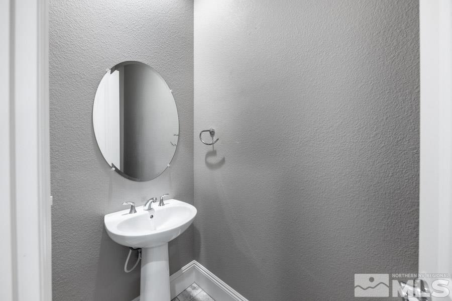 9405 Stony Hill Road Reno, NV 89521 - Photo 27 of 37 a bathroom with a sink and mirror