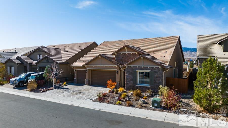 9405 Stony Hill Road Reno, NV 89521 - Photo 34 of 37 a view of a house with a small yard and potted plants