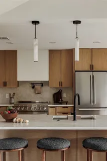 a kitchen with stainless steel appliances granite countertop a sink a stove and a refrigerator