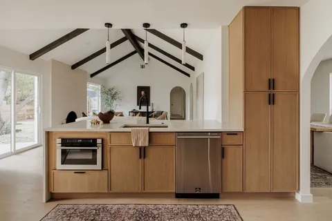 a kitchen with stainless steel appliances a sink and cabinets