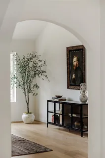 a living room with furniture and a potted plant