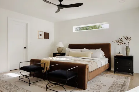 a bedroom with a bed and a table