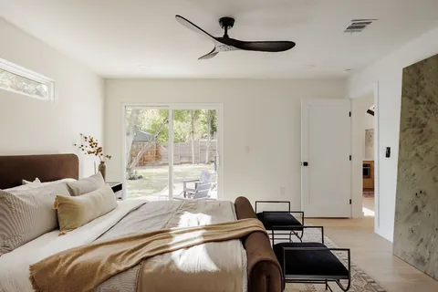 a bedroom with furniture or window and a ceiling fan