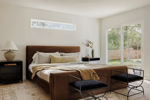 a bedroom with a bed and a couch