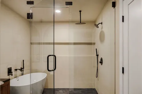 a bathroom with a bathtub and shower