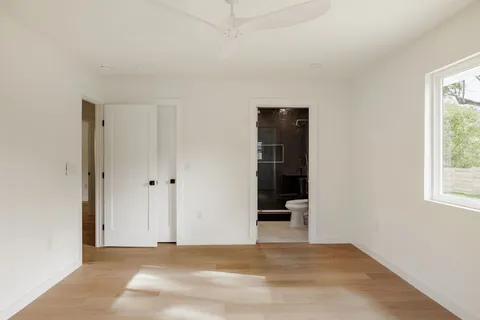 an empty room with windows and closet