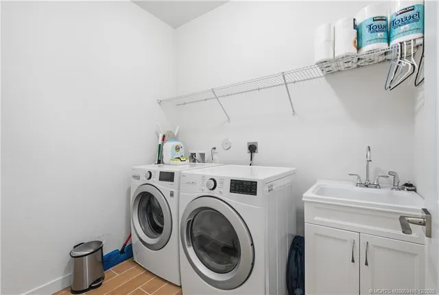 a view of a patio with table and chairs and potted plants