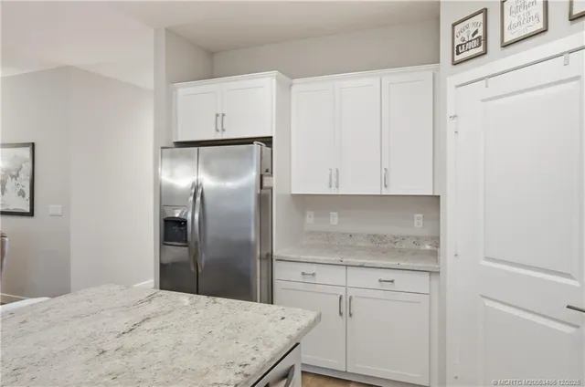a kitchen with white cabinets stainless steel appliances and sink