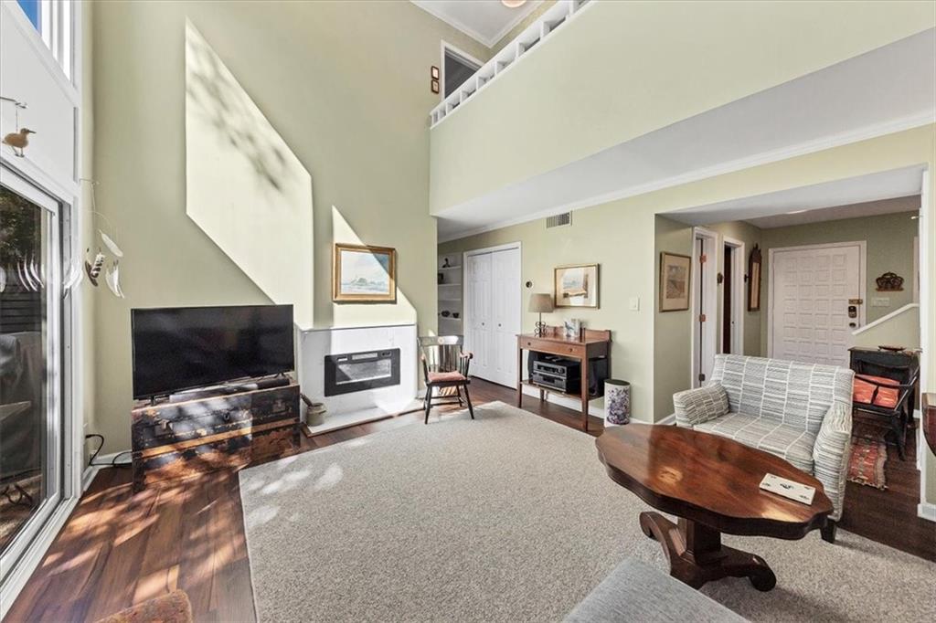 45 Forrest Place Northeast Atlanta, GA 30328 - Photo 14 of 51 a living room with furniture a flat screen tv and a fireplace