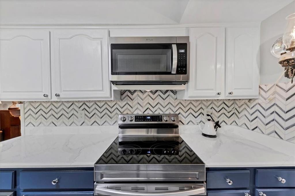 45 Forrest Place Northeast Atlanta, GA 30328 - Photo 19 of 51 a kitchen with granite countertop white cabinets and stainless steel appliances