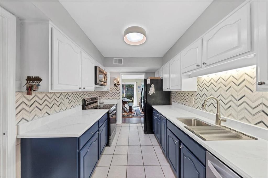 45 Forrest Place Northeast Atlanta, GA 30328 - Photo 21 of 51 a kitchen with stainless steel appliances granite countertop a sink stove and refrigerator
