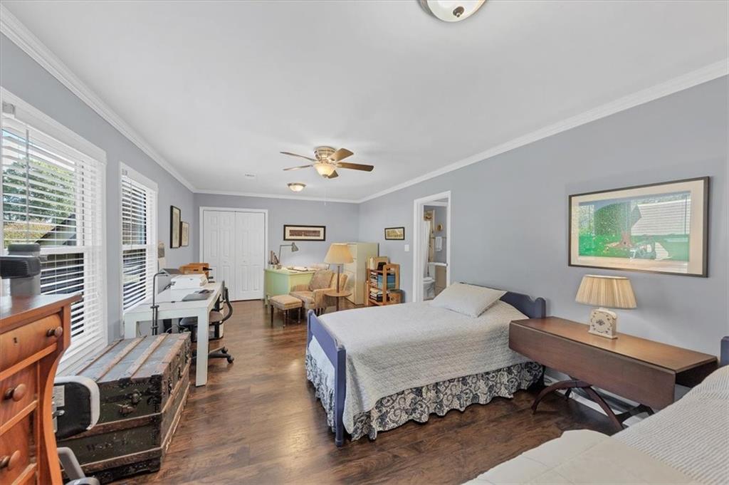 45 Forrest Place Northeast Atlanta, GA 30328 - Photo 27 of 51 a bedroom with a bed and wooden floor