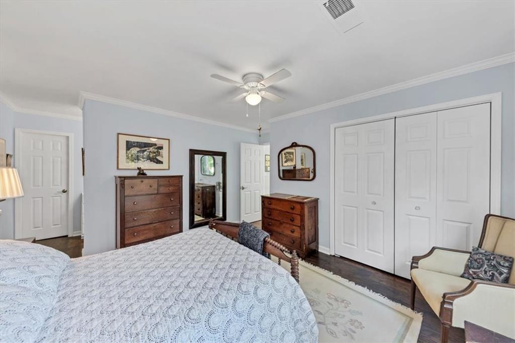 45 Forrest Place Northeast Atlanta, GA 30328 - Photo 33 of 51 a bedroom with a bed and a chandelier