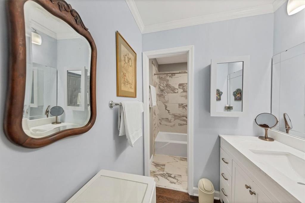 45 Forrest Place Northeast Atlanta, GA 30328 - Photo 34 of 51 a bathroom with a sink a mirror a toilet and a glass door shower